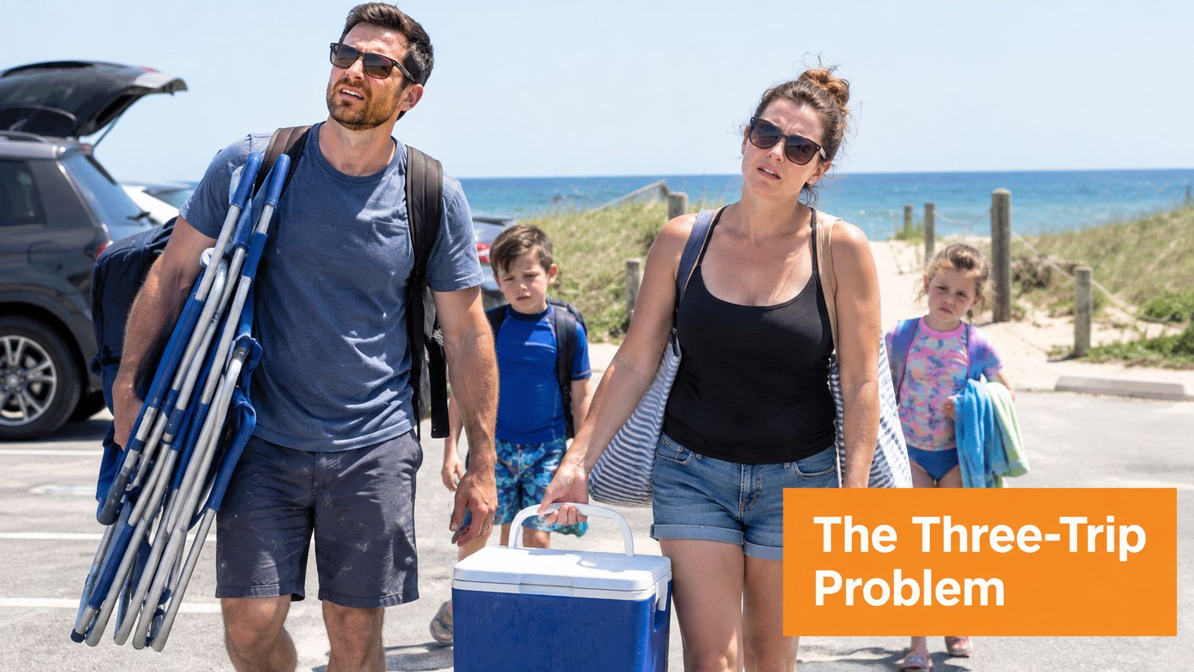 A family of four walking from their car to the beach while carrying various gear.