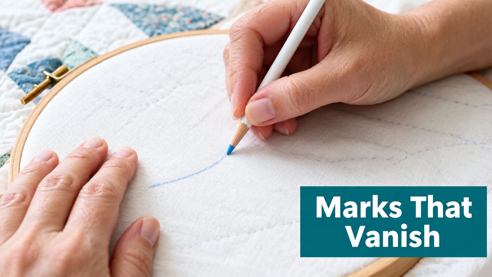 A close-up view of a person using a fabric marking pencil on white cloth inside an embroidery hoop.