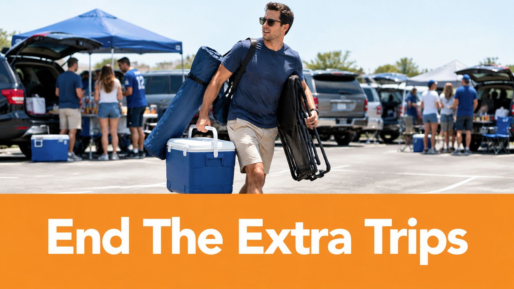 A man carries a cooler, a folding chair, and equipment through a parking lot during a tailgate event.