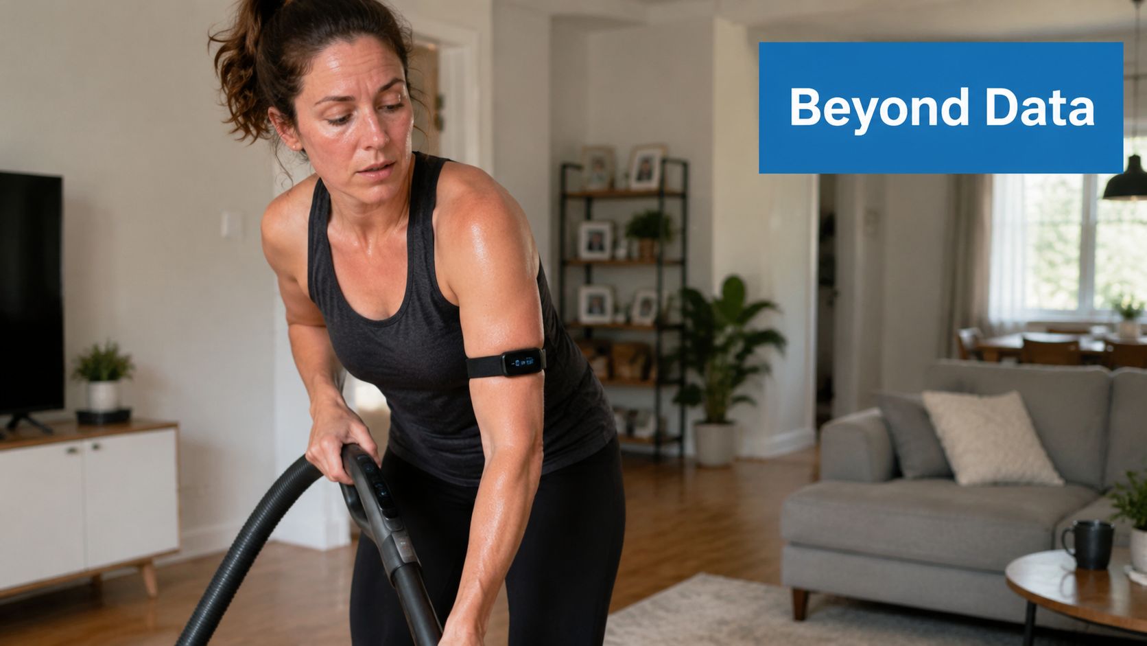 A woman wearing a fitness tracker on her arm while cleaning her home with a vacuum cleaner.