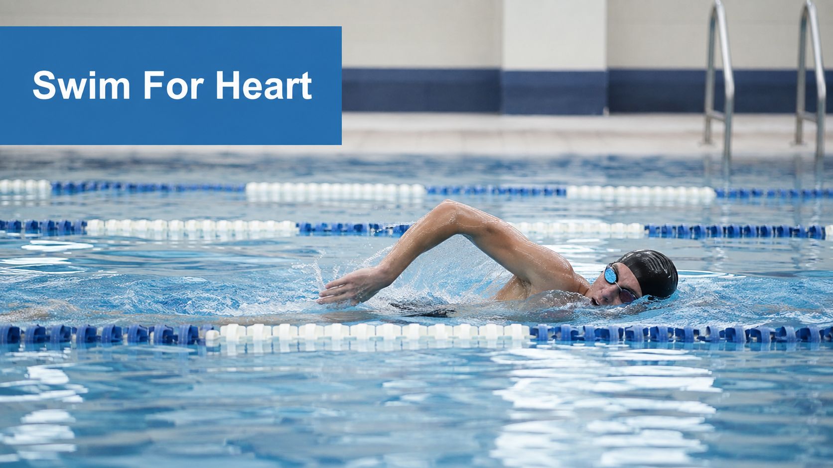 A fit male swimmer wearing goggles and a cap swimming freestyle in a blue competition pool.