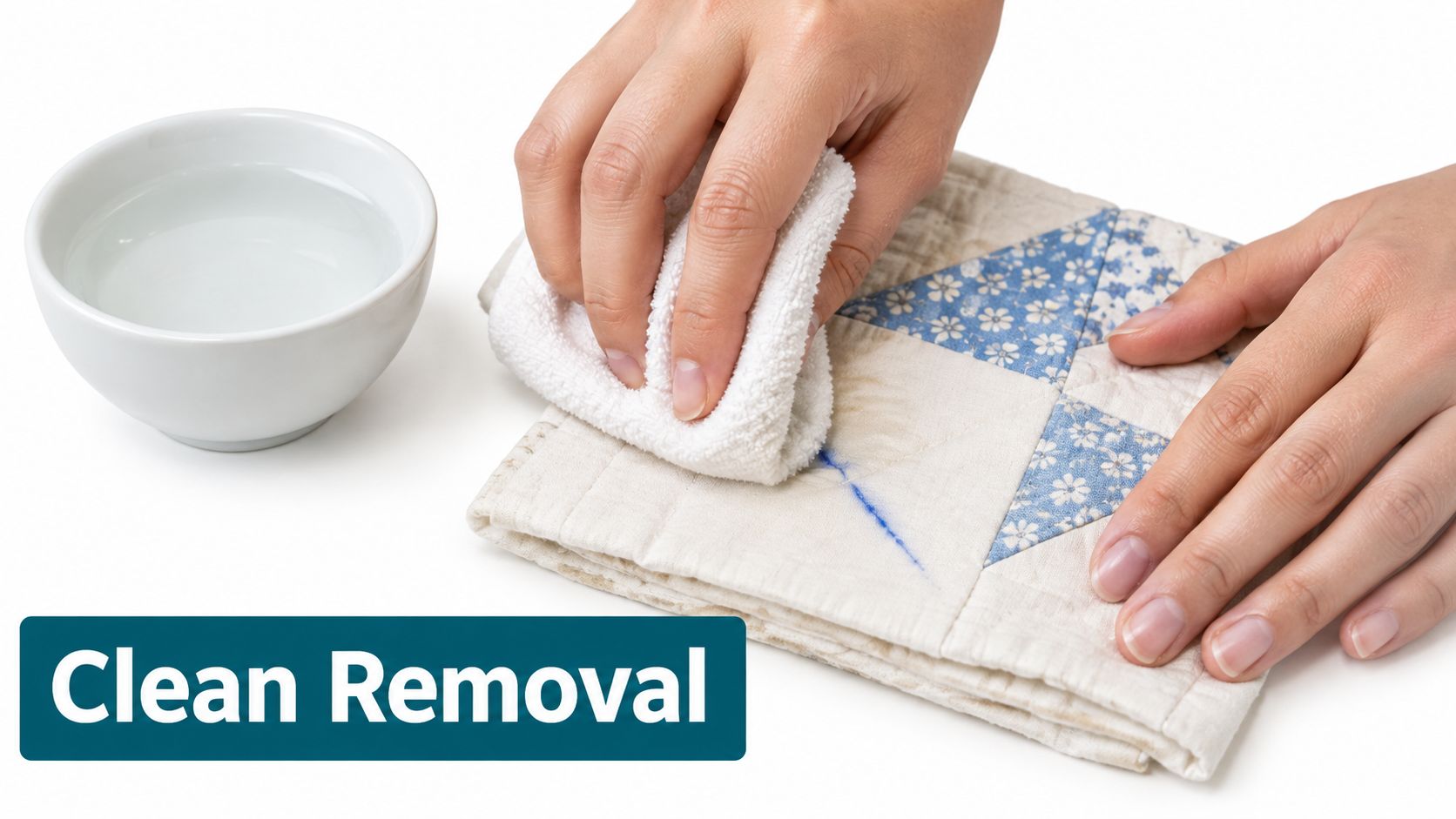 A person uses a damp white cloth to remove blue ink markings from a quilted fabric square.