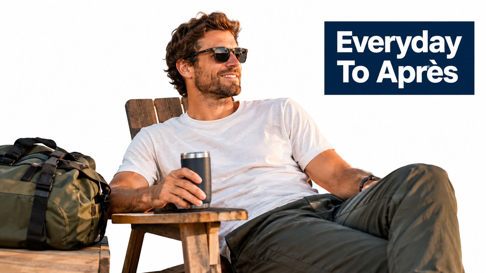 A man wearing a white short sleeve t-shirt and sunglasses relaxing in a wooden chair outdoors.