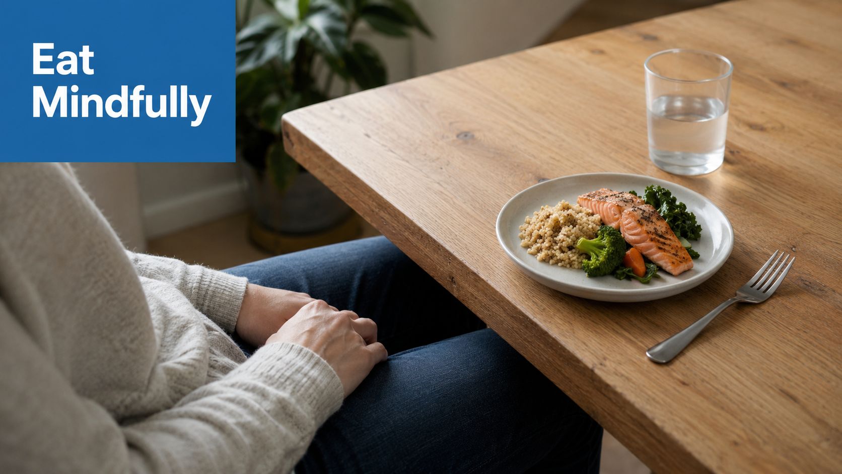 A person sitting at a wooden table with a healthy meal of salmon, grains, and vegetables.