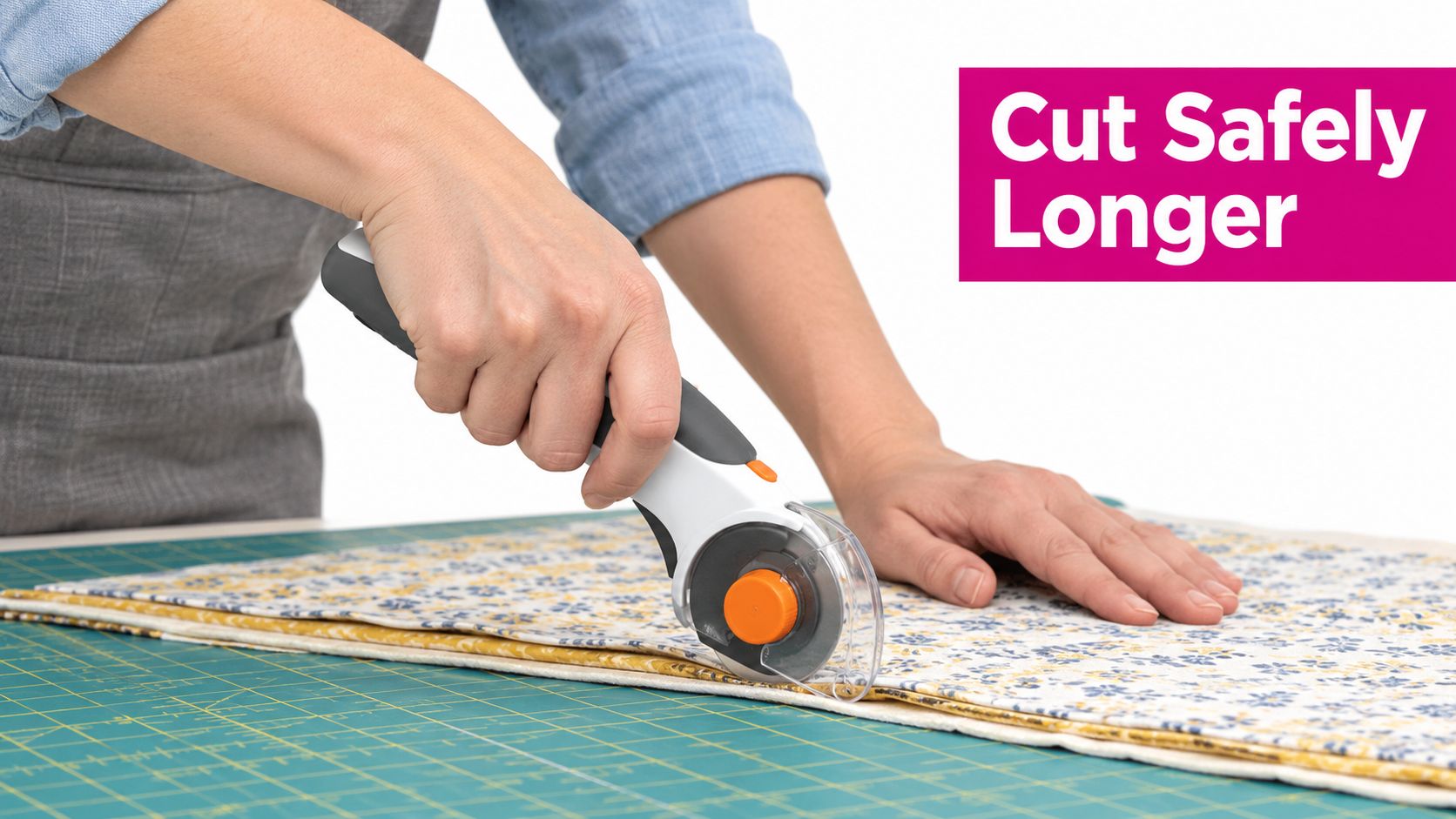 A person uses a rotary cutter to slice through layers of floral and yellow fabric on a mat.