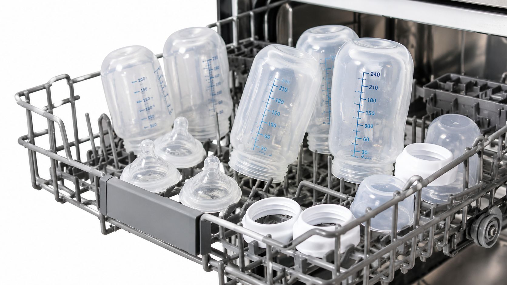 A close-up of several baby bottles placed in the top rack of a dishwasher, illustrating the concept of being dishwasher safe.