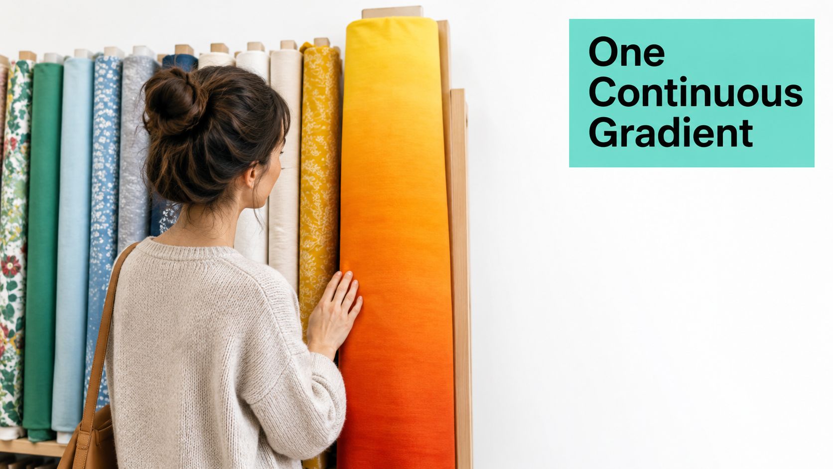 A woman examining a roll of vibrant yellow to orange ombre fabric on a retail store shelf.