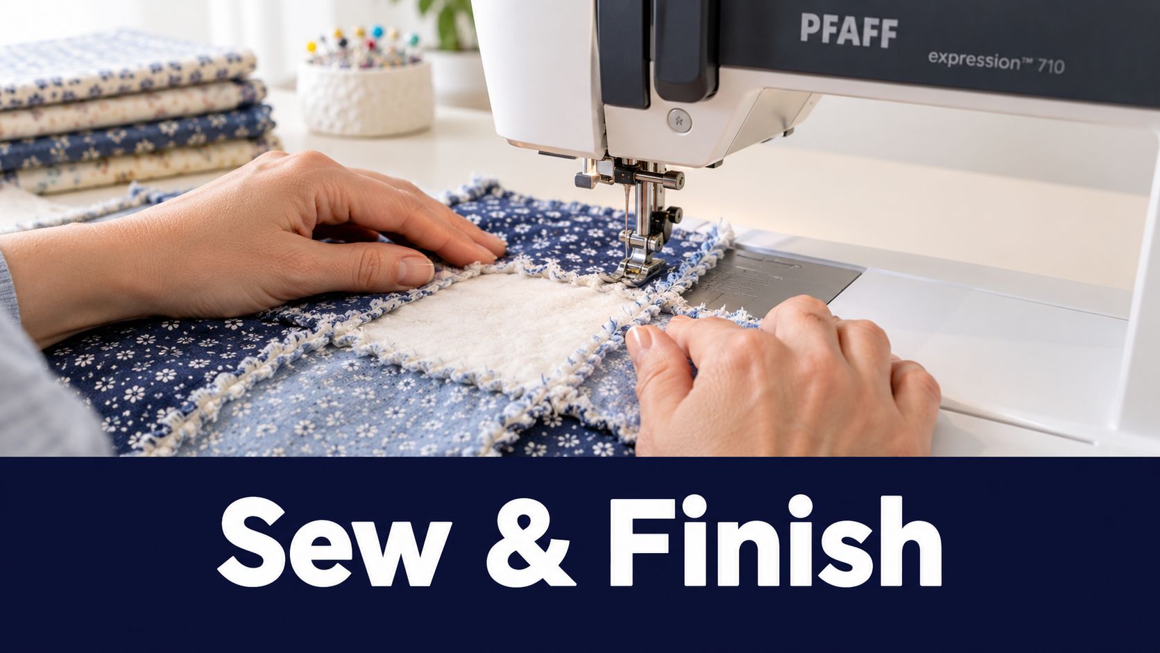 A pair of hands using a PFAFF sewing machine to stitch together a blue rag quilt.