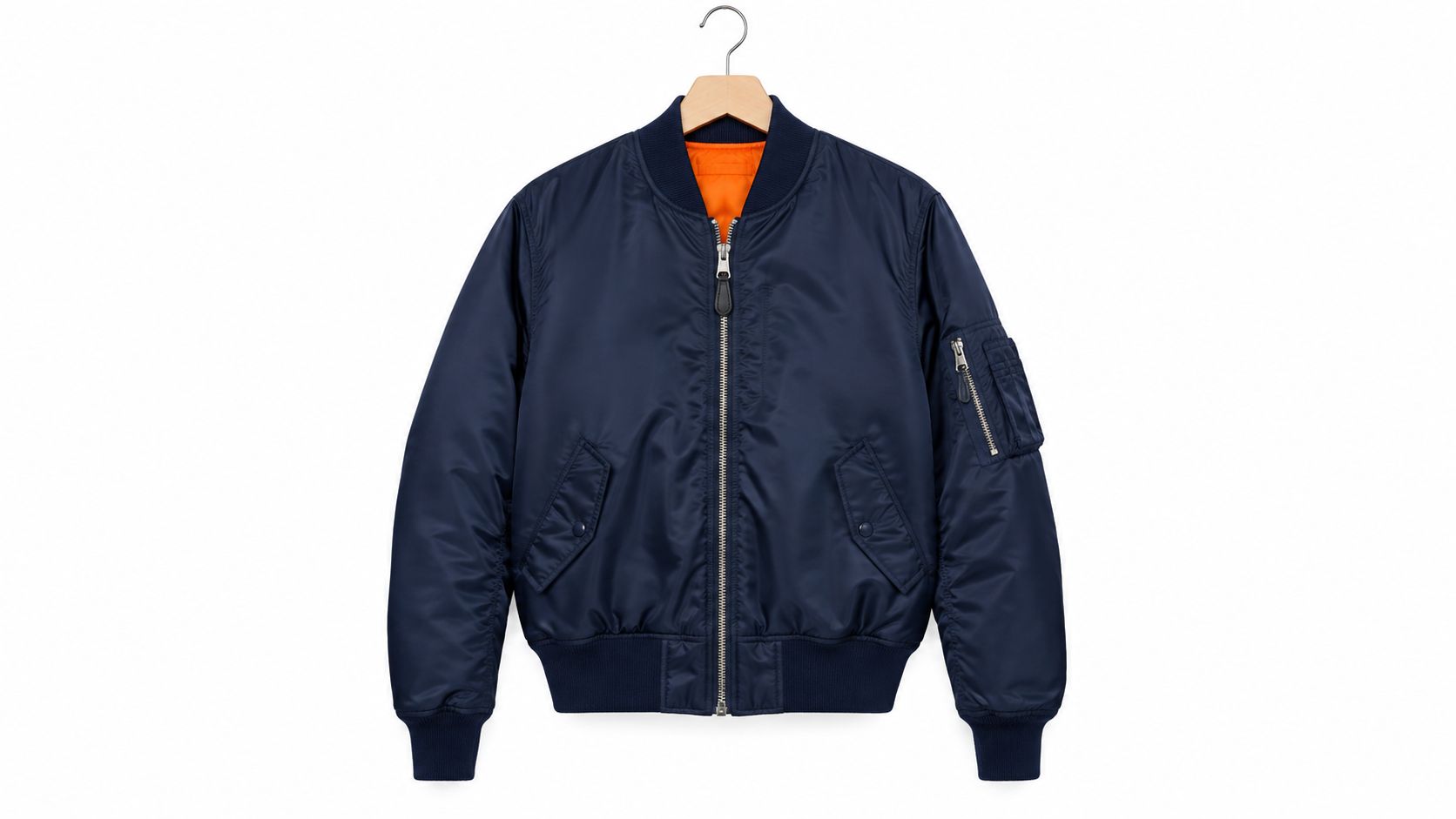 A navy blue bomber jacket with an orange lining hanging on a wooden hanger against white background.