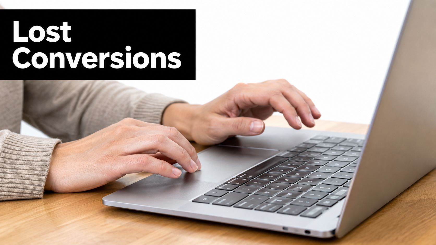 A person using a laptop computer on a wooden desk, representing issues with website conversions.