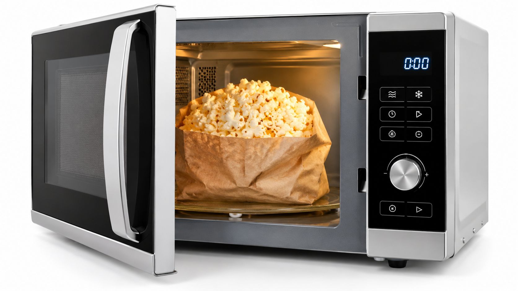 A silver microwave with its door open, containing a paper bag filled with freshly popped popcorn.