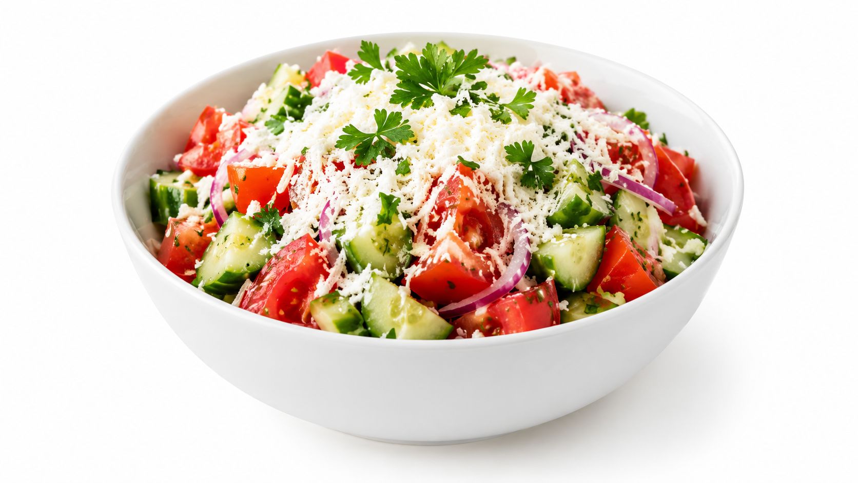 A fresh Bulgarian Shopska salad served in a white bowl with tomatoes, cucumbers, onions, and crumbled cheese.