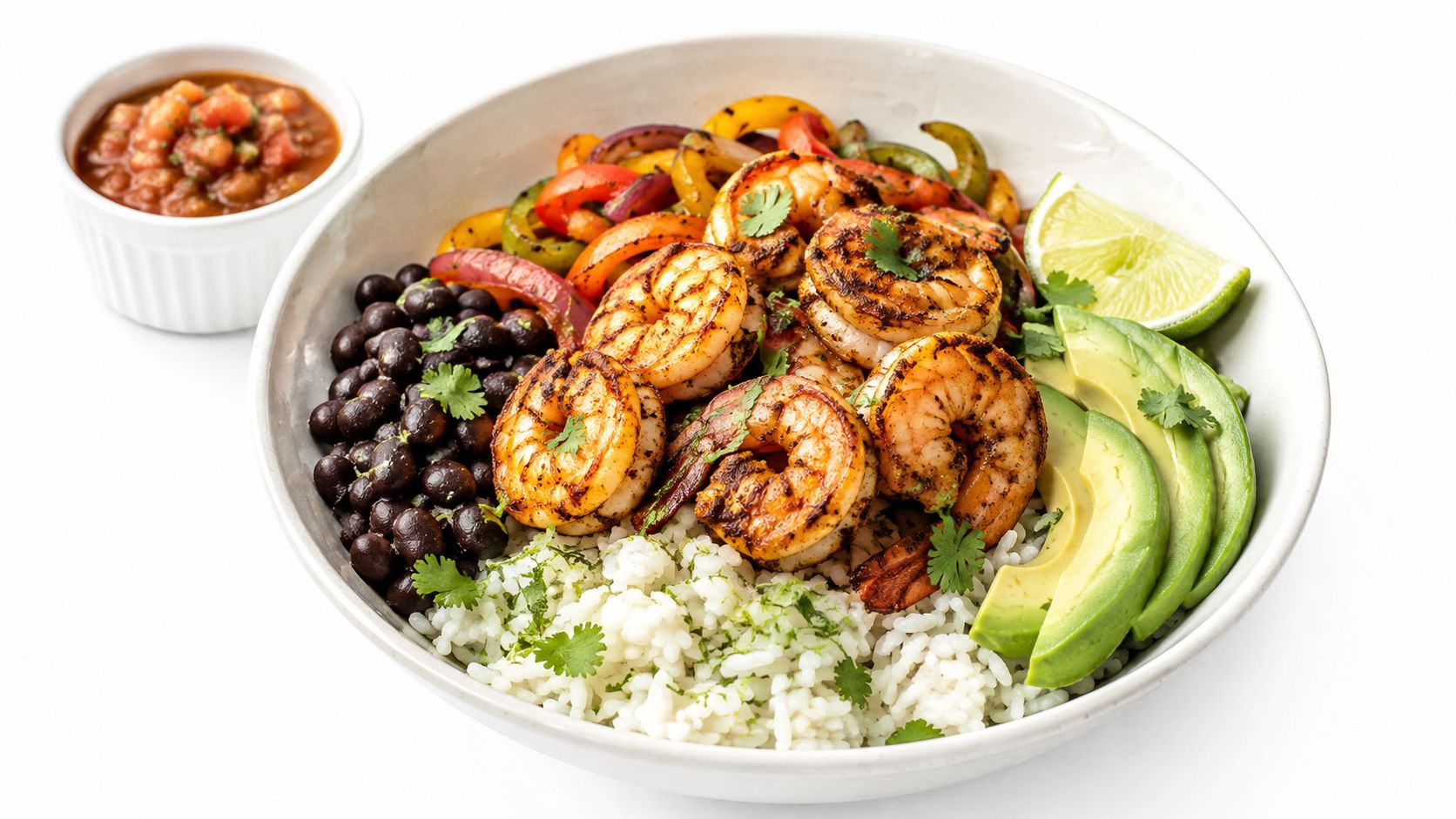 A healthy shrimp burrito bowl featuring grilled shrimp, black beans, rice, avocado, peppers, and a side of salsa.