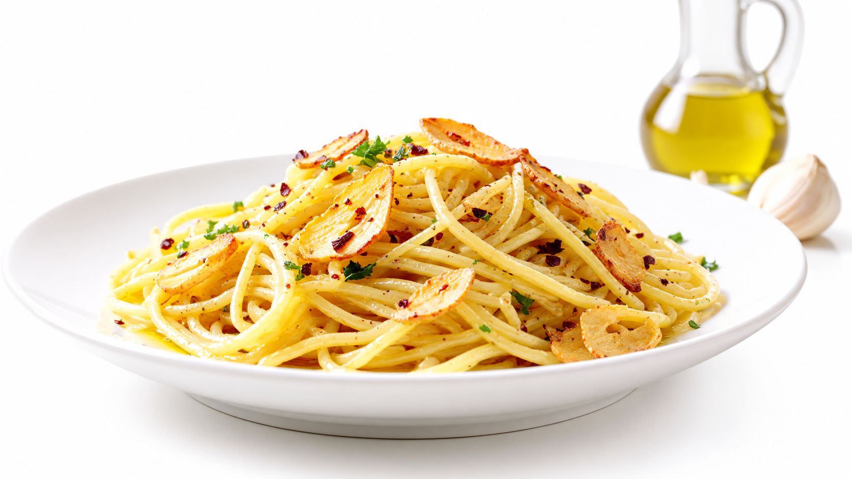 A plate of spaghetti aglio e olio topped with crispy garlic slices and red pepper flakes.