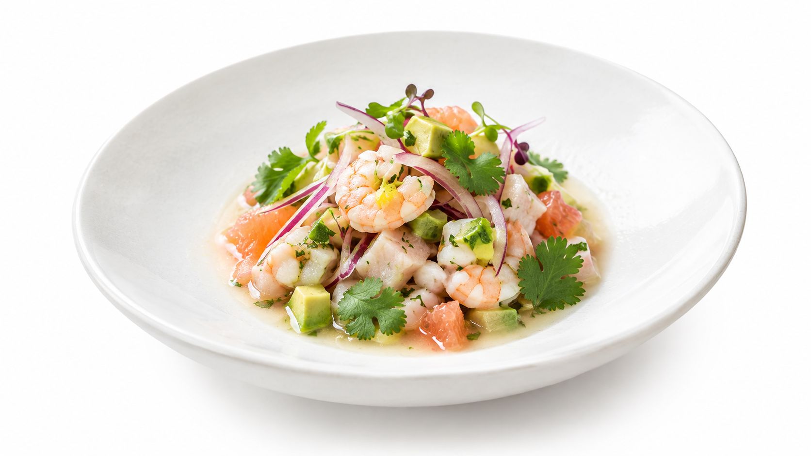 A gourmet ceviche bowl featuring fresh shrimp, diced avocado, red onion, grapefruit segments, and fresh cilantro leaves.