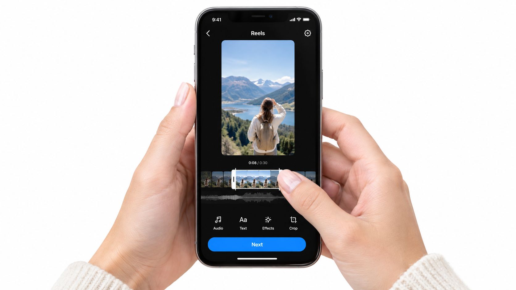 A person holding a smartphone editing a video clip in the Instagram Reels interface on a screen.