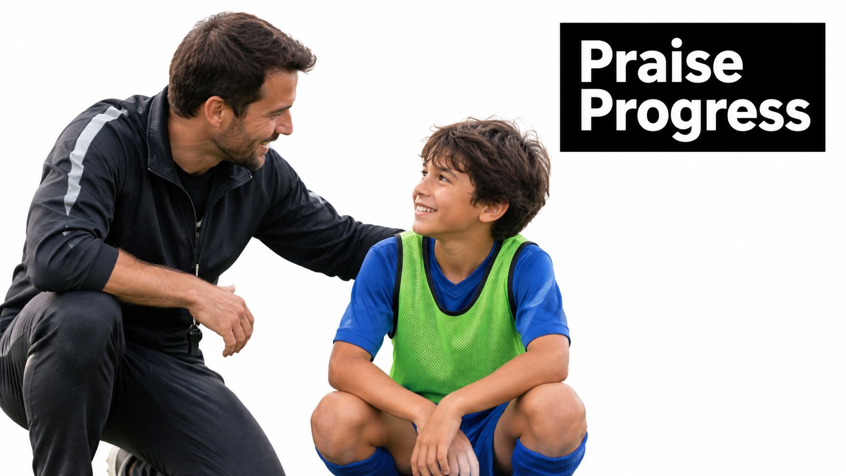 A supportive youth soccer coach kneeling and talking to a smiling young player on the field.