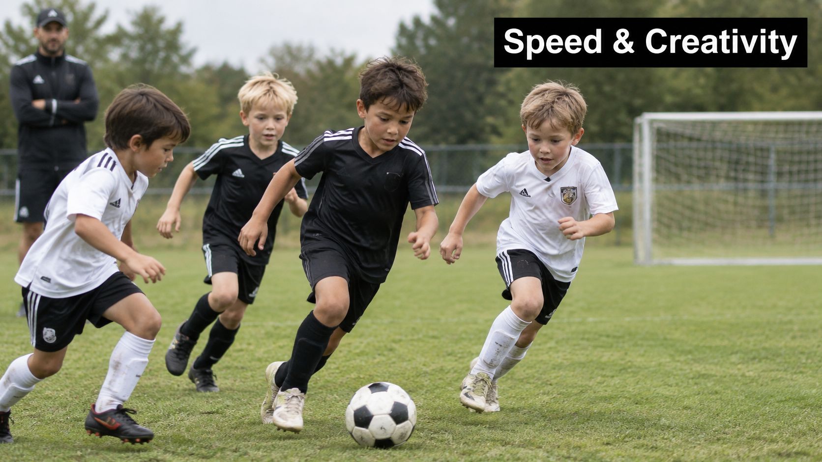 A group of young children playing a competitive soccer game on a grassy sports field.