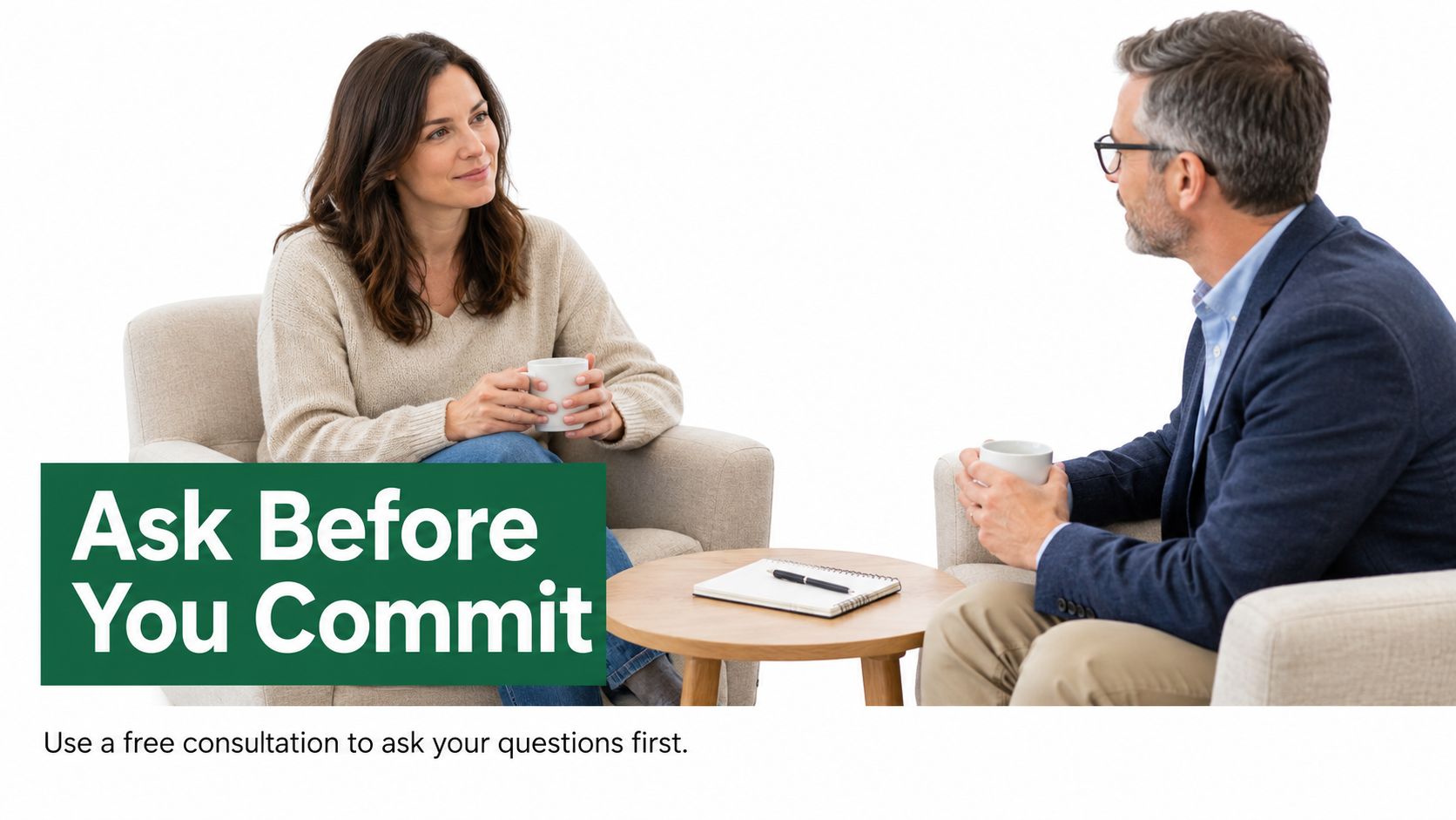 A professional man and woman sitting in armchairs having a friendly, relaxed consultation with cups of coffee.
