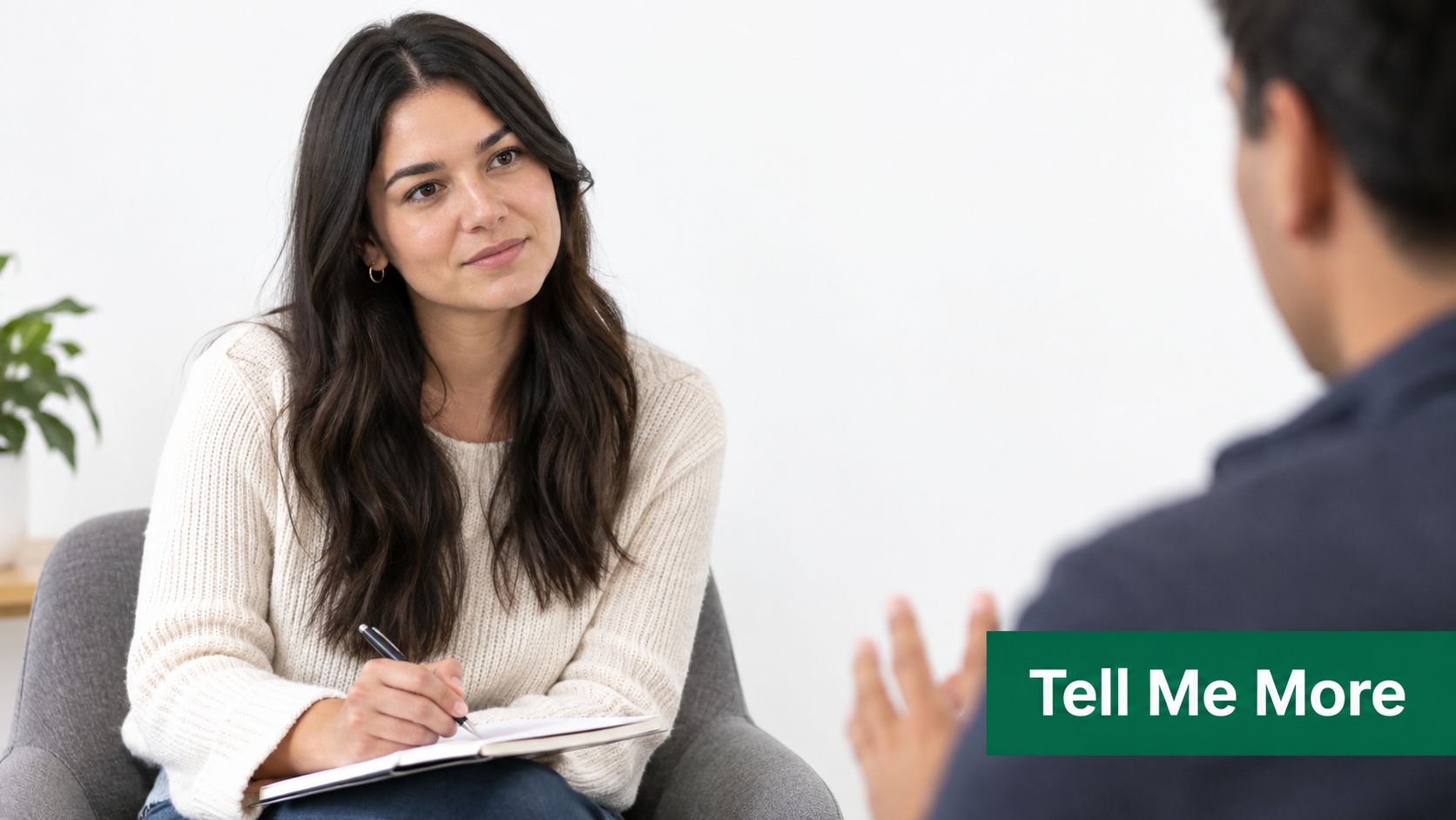 A professional therapist actively listening and taking notes during a counseling session with a patient.