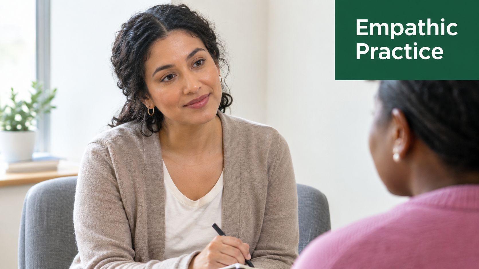 A therapist listens attentively to her client while taking notes during a culturally sensitive therapy session.