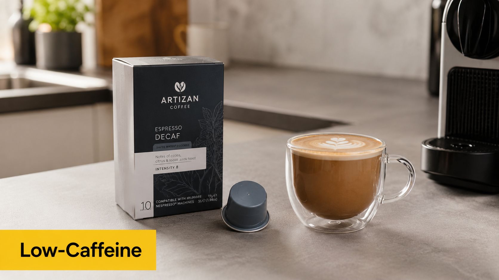 A box of Artizan Coffee decaf espresso pods and a fresh cappuccino on a kitchen counter.