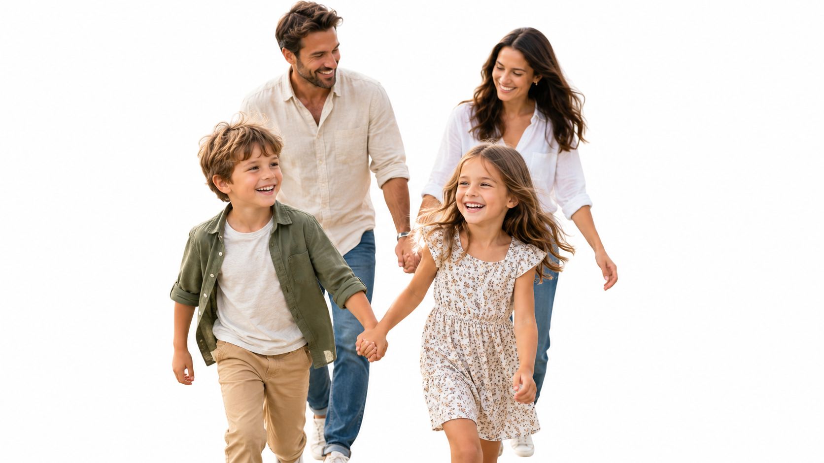 A happy family of four walking hand in hand towards the camera against a white background.