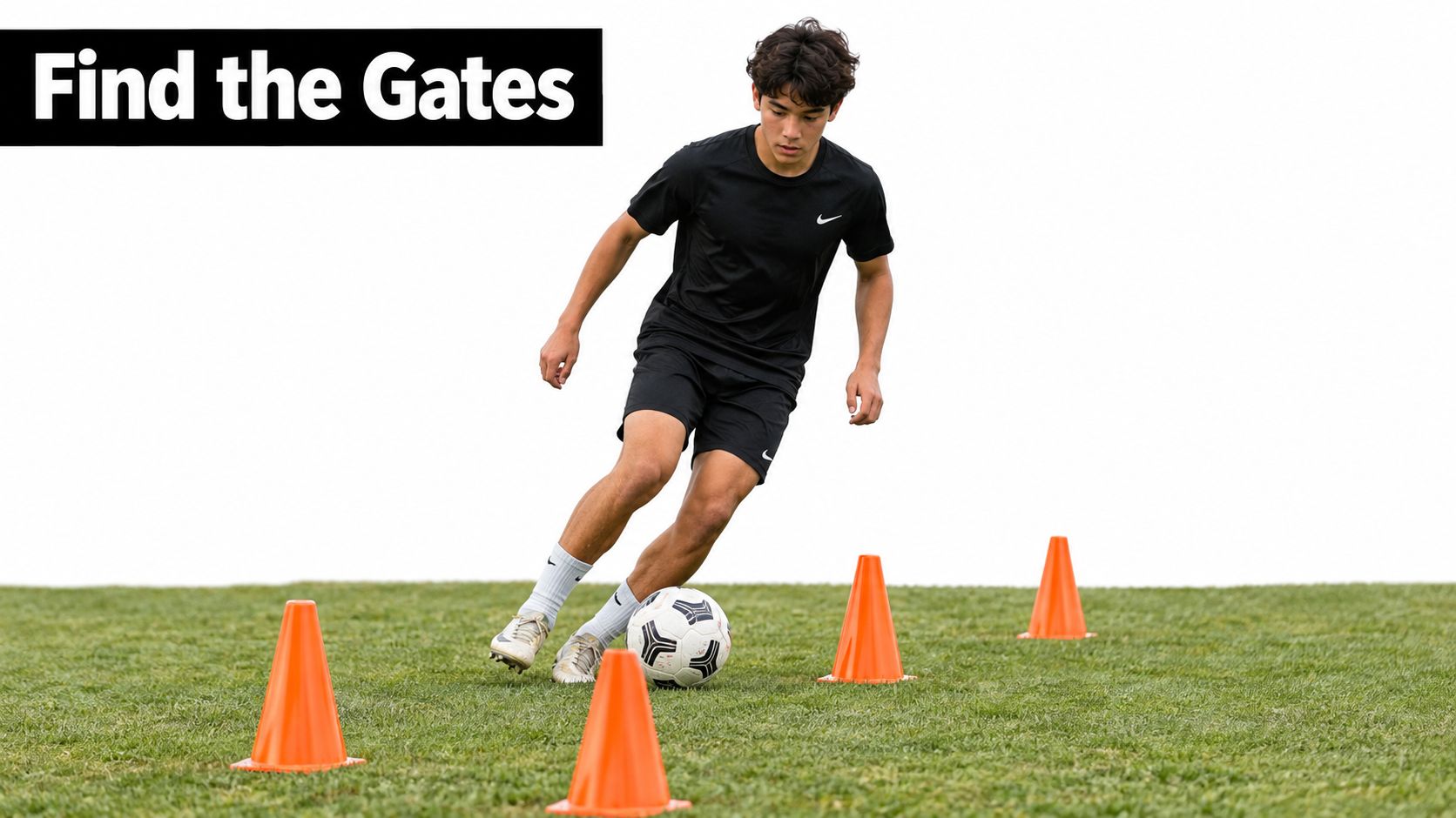 A teenage soccer player dribbling a ball through orange training cones on a grass field.