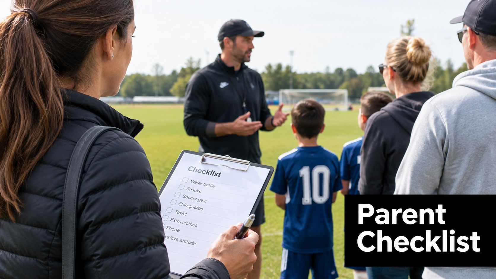 A woman holding a checklist on a clipboard while standing at a youth soccer practice field.