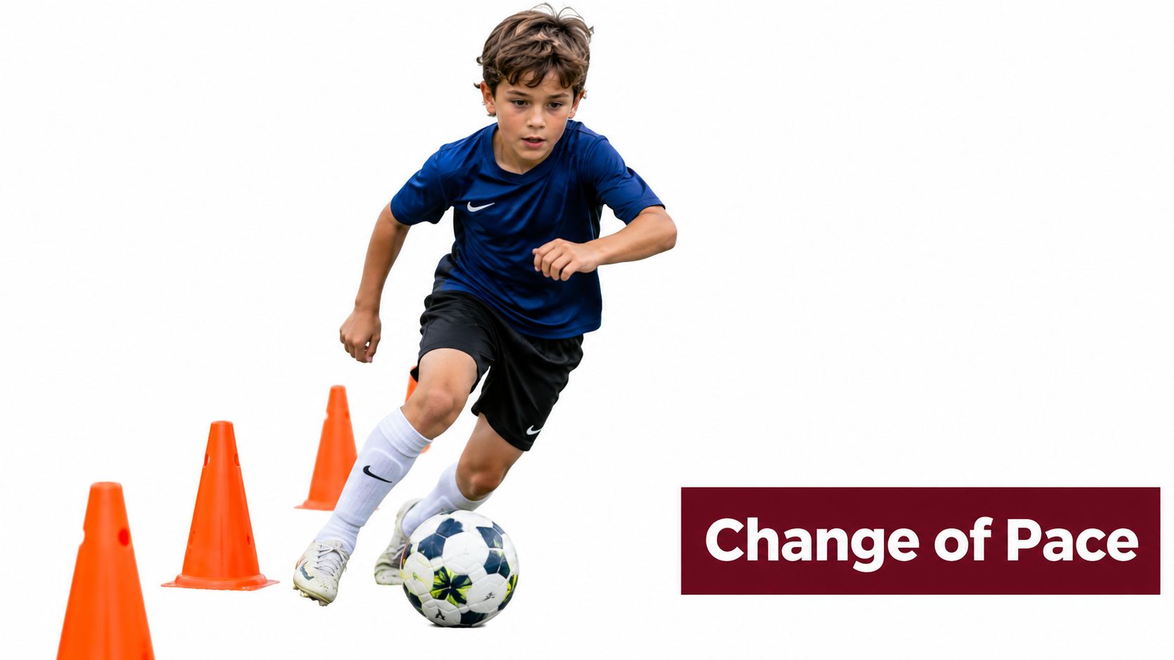 A young boy in a blue soccer uniform practicing dribbling drills through orange cones on a field.