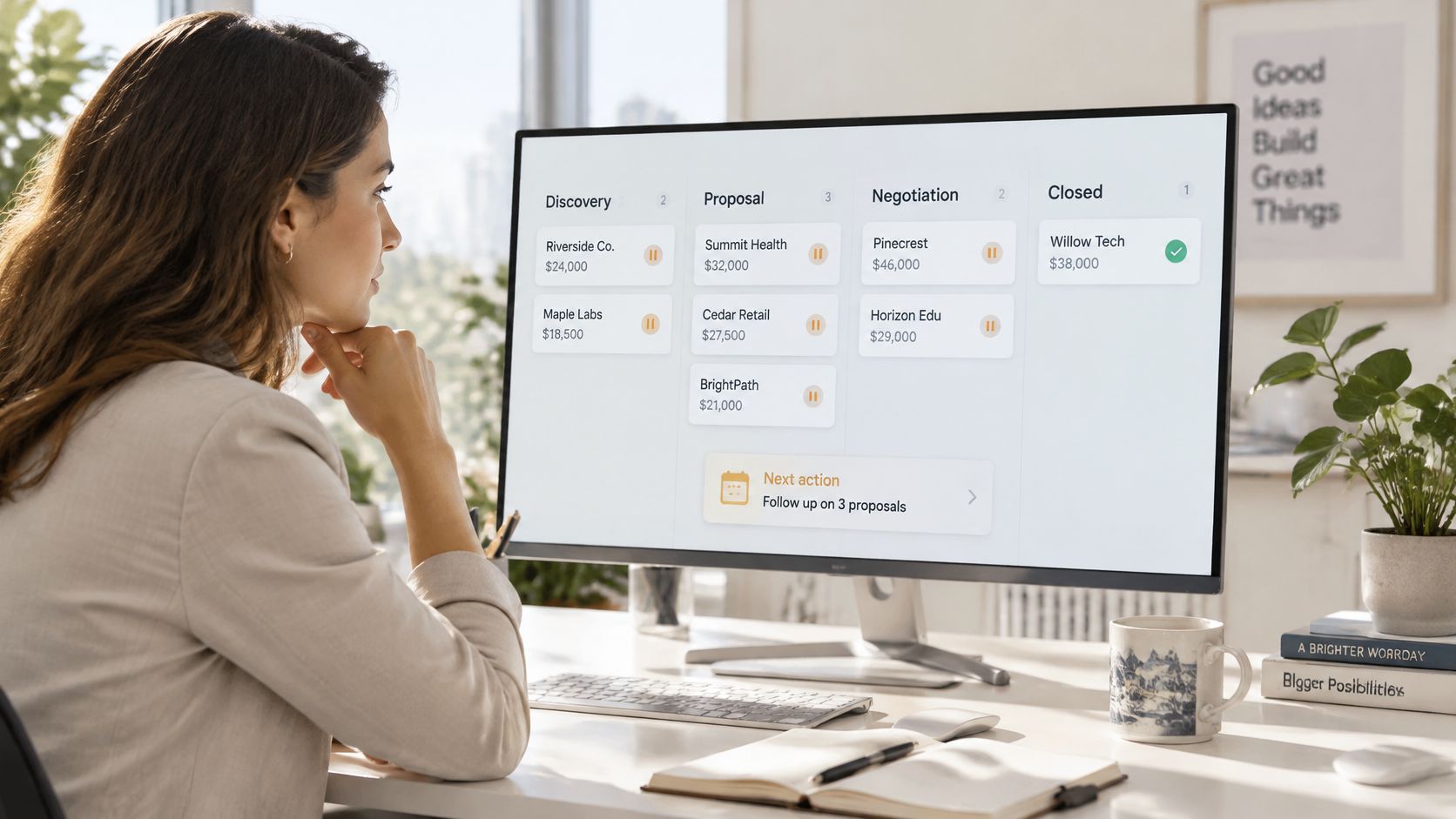 A professional woman looking at a computer screen displaying a sales pipeline dashboard in a bright office.