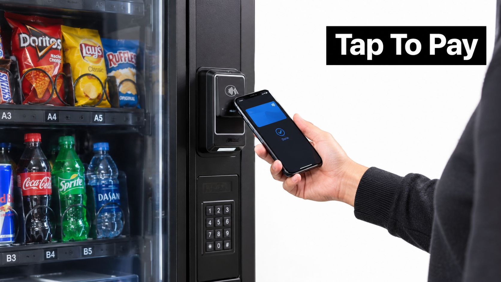 A person pays for snacks at a vending machine using their smartphone with contactless tap technology.