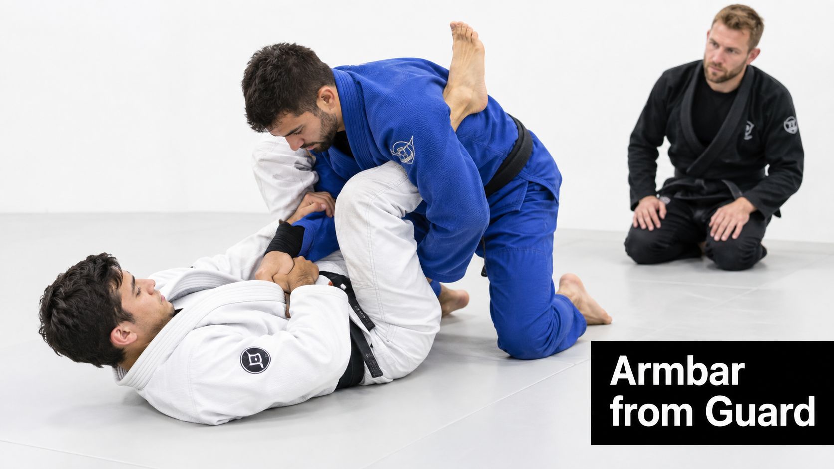 A practitioner demonstrates an armbar submission from guard position during a Brazilian Jiu-Jitsu training session.