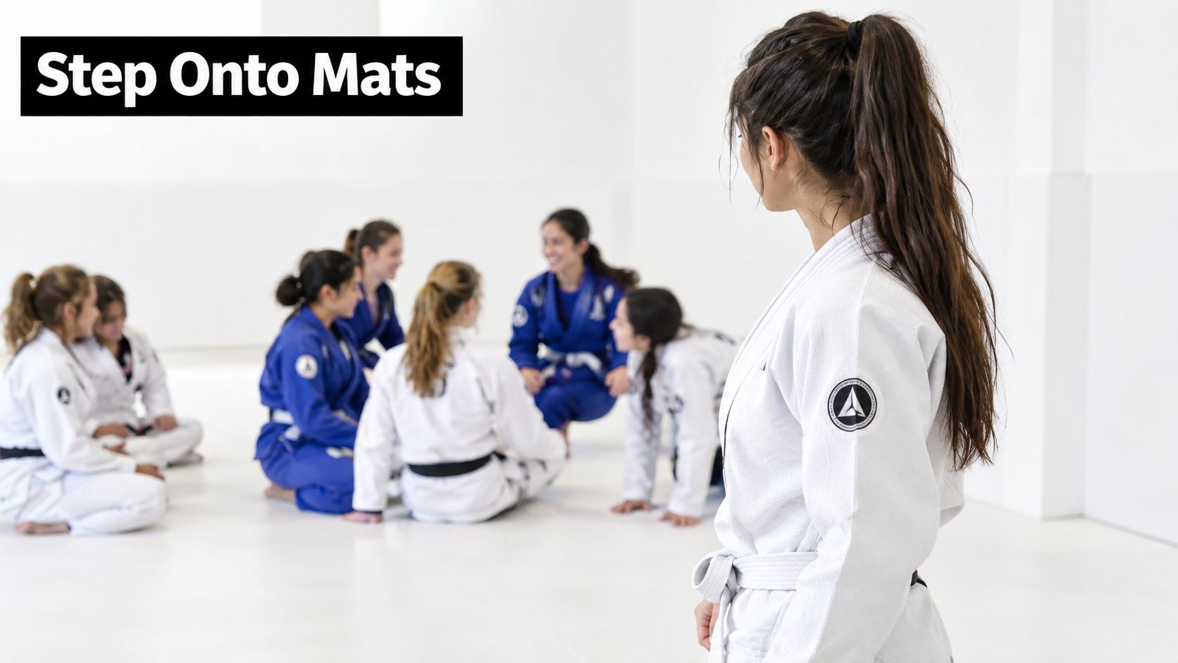 A woman in a white gi watches a group of women training in a bright gym setting.
