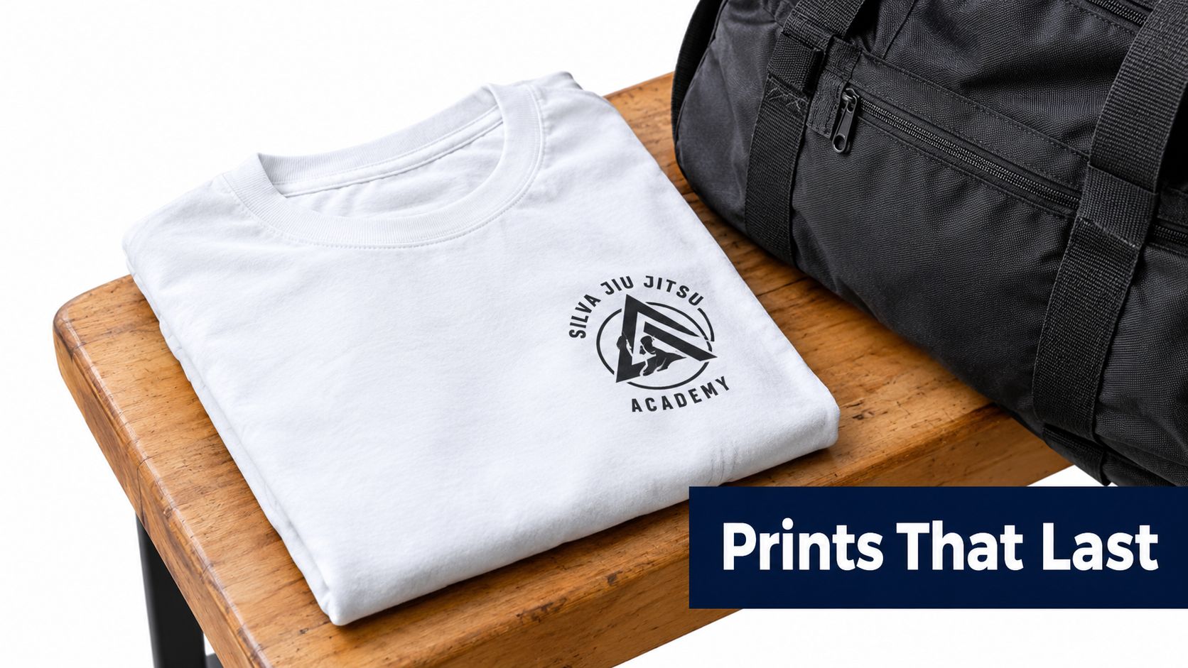 A white t-shirt with a Silva Jiu Jitsu Academy logo resting on a wooden bench beside a gym bag.