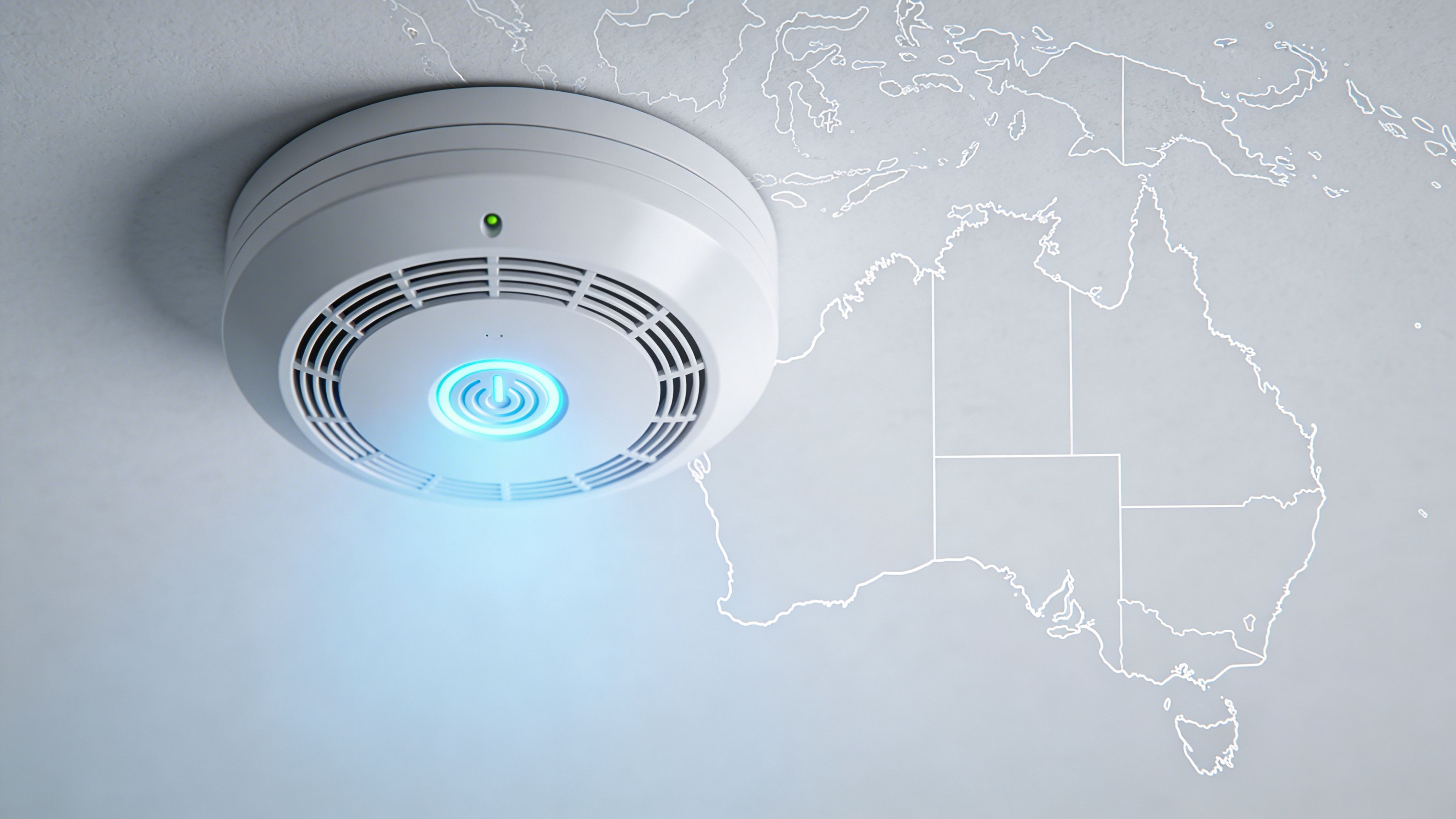 A Modern White Smoke Detector Mounted On A Wall Featuring An Outline Map Of Australia.