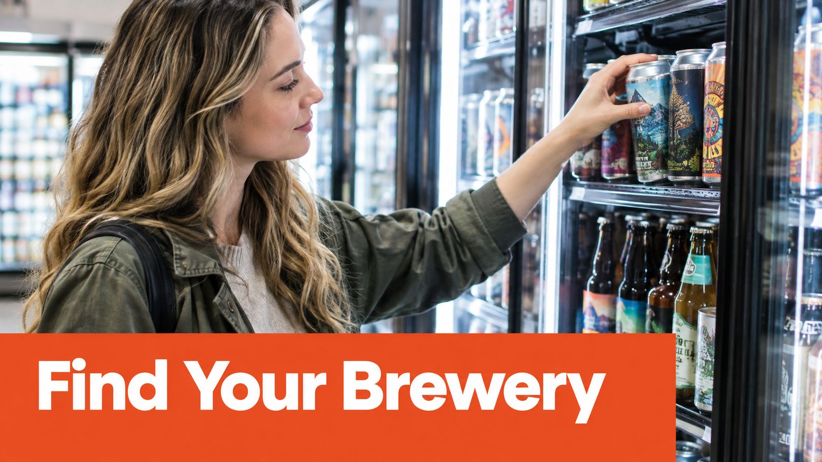 A woman with wavy blonde hair choosing a craft beer from a refrigerated display case.