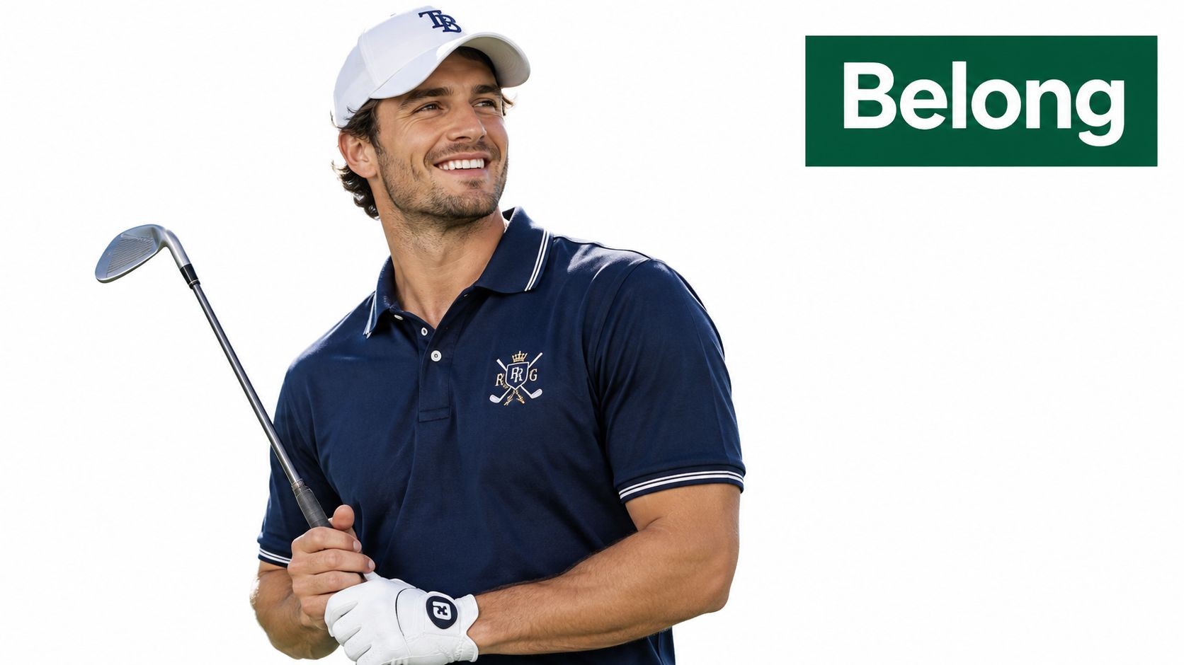 A smiling male golfer in a navy polo shirt with a crown logo and white baseball cap.