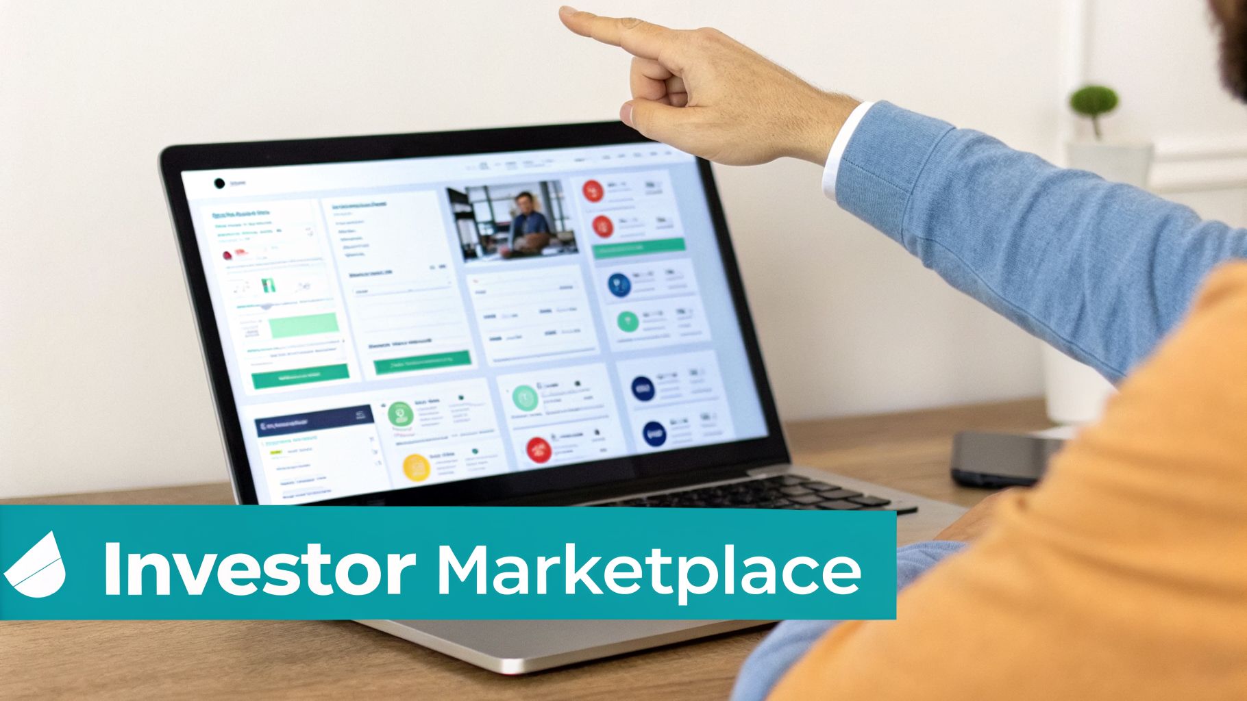 Man's hand pointing to a laptop screen showing an 'Investor Marketplace' dashboard on a wooden desk.