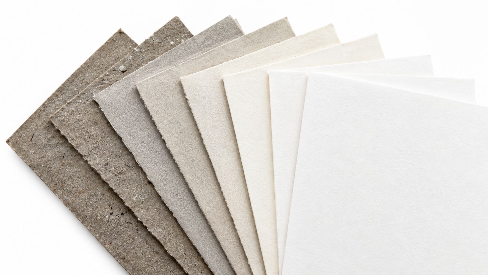 Ein Fächer aus verschiedenen Papier- und Kartonmustern, sortiert von dunkelgrau nach leuchtendem Weiß auf hellem Hintergrund.