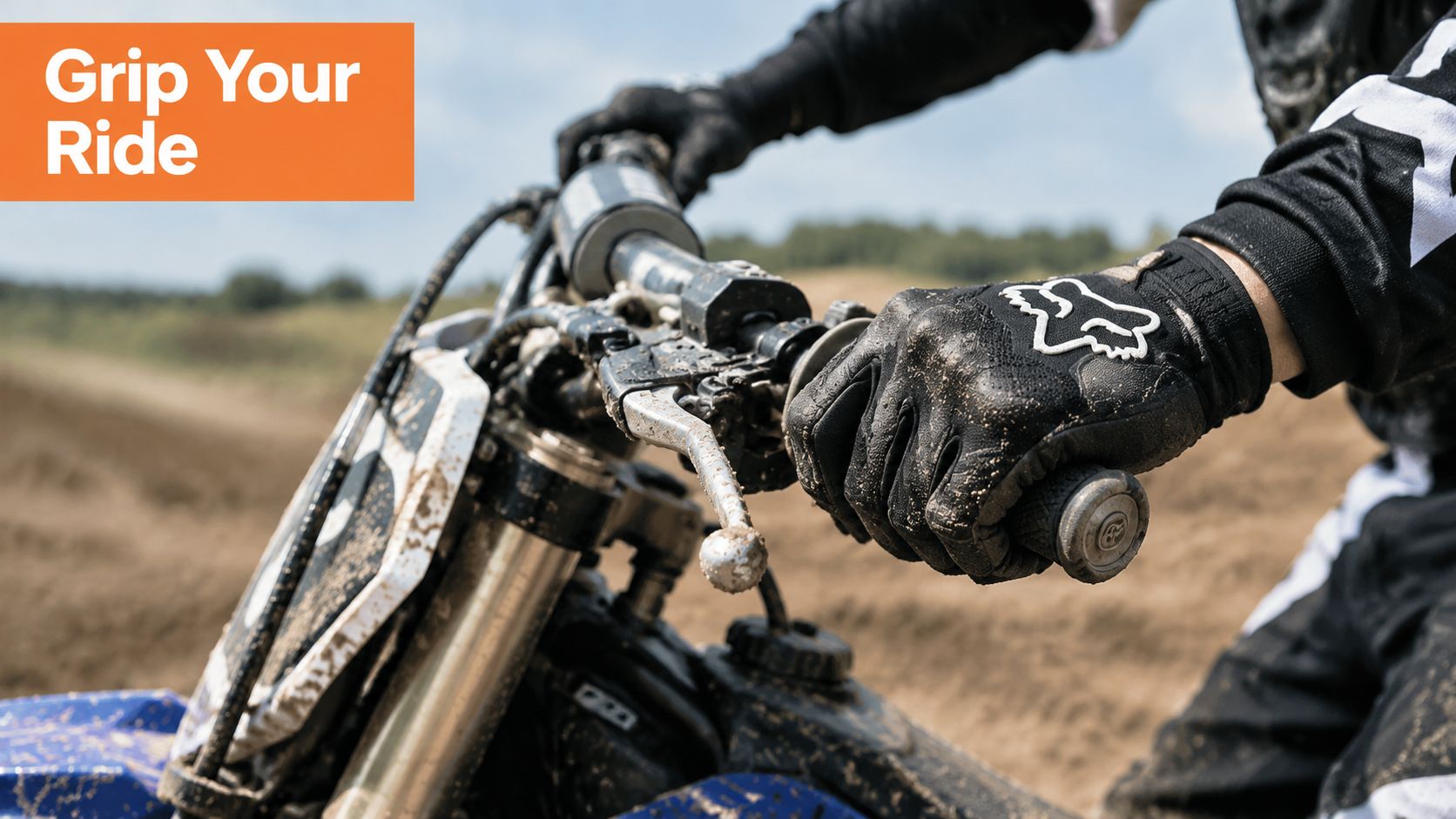A close-up view of a motocross rider gripping the handlebars of a dirt bike while wearing gloves.