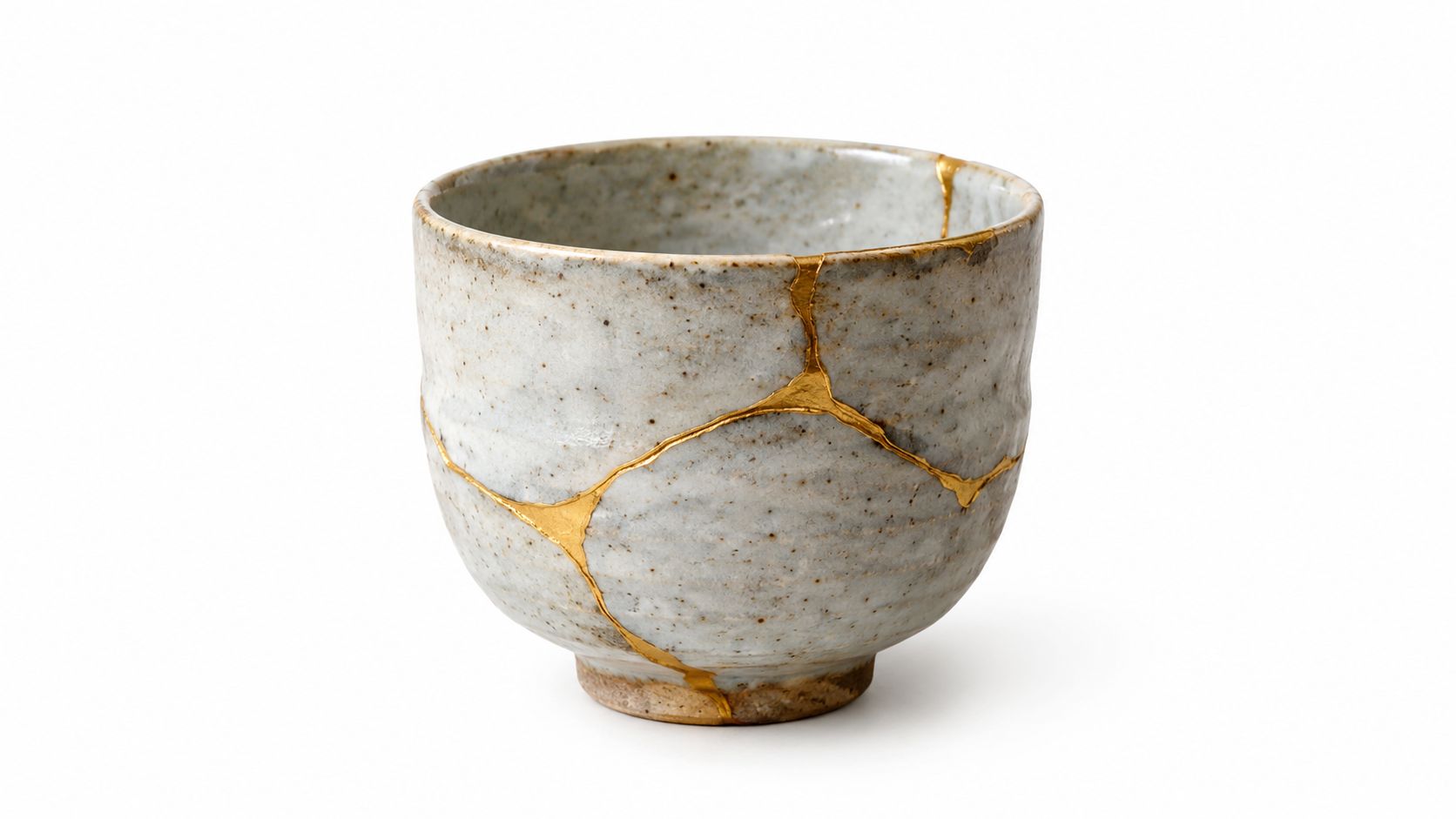 A handcrafted Japanese kintsugi tea bowl with golden cracks, showcasing the art of repairing broken pottery.