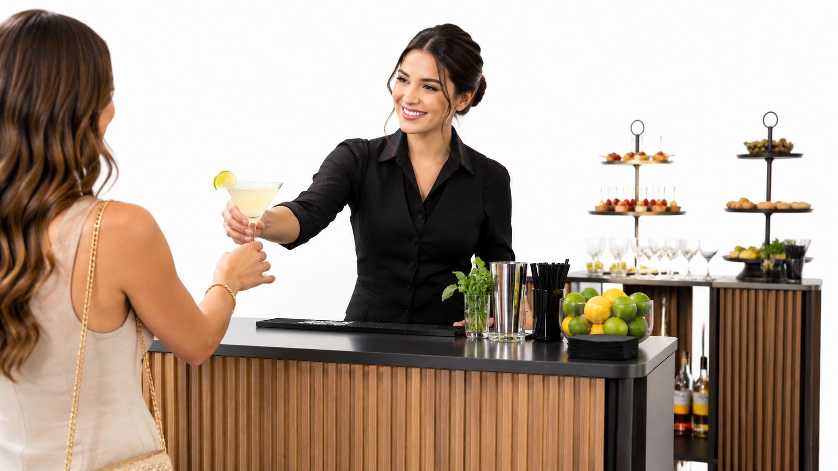 Woman bartender handing a cocktail to a guest at a portable bar.