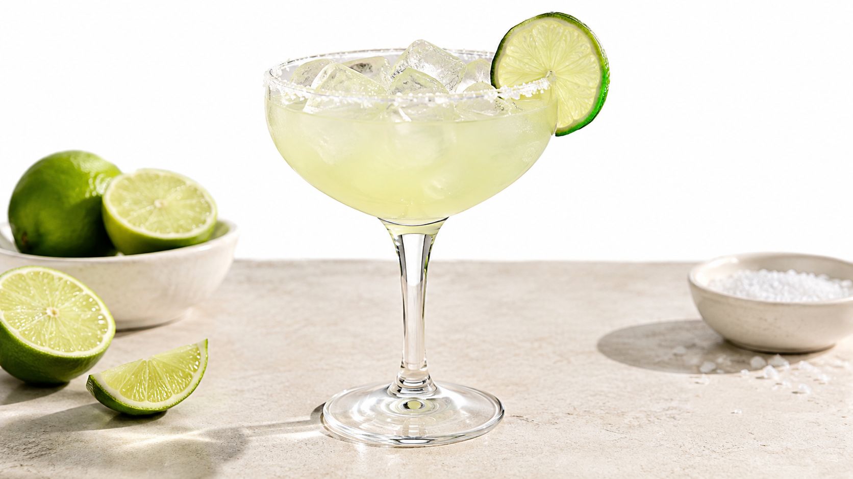 A refreshing margarita cocktail served in a classic glass with a salted rim and lime garnish.