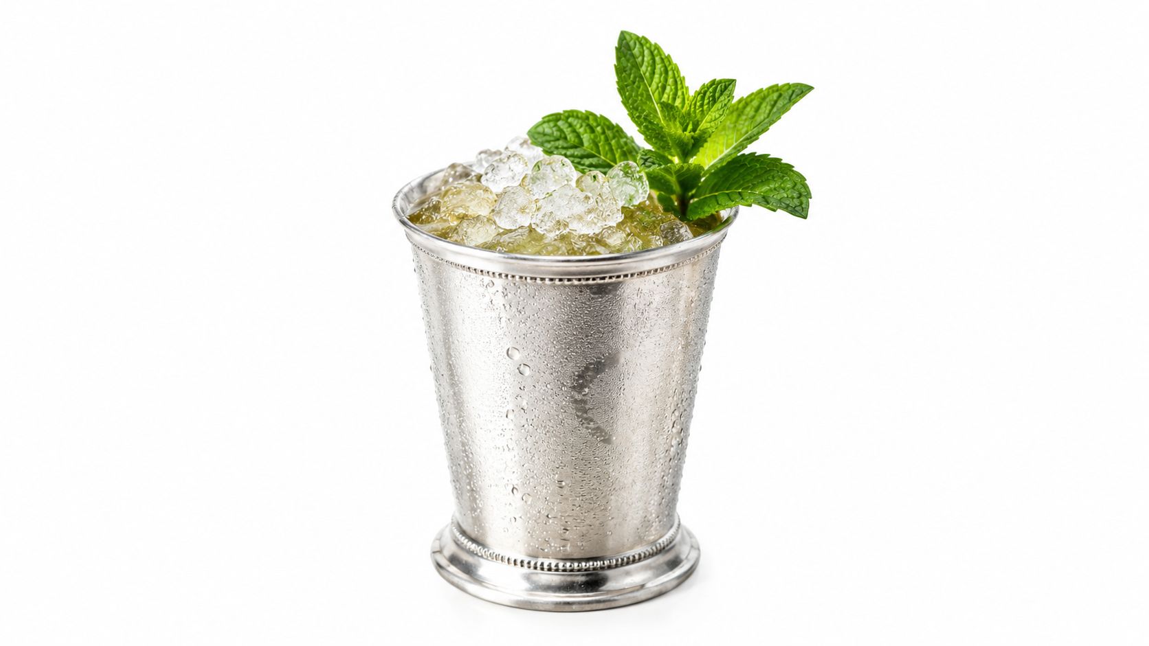 Fresh mint sprigs in a metal julep cup filled with crushed ice.