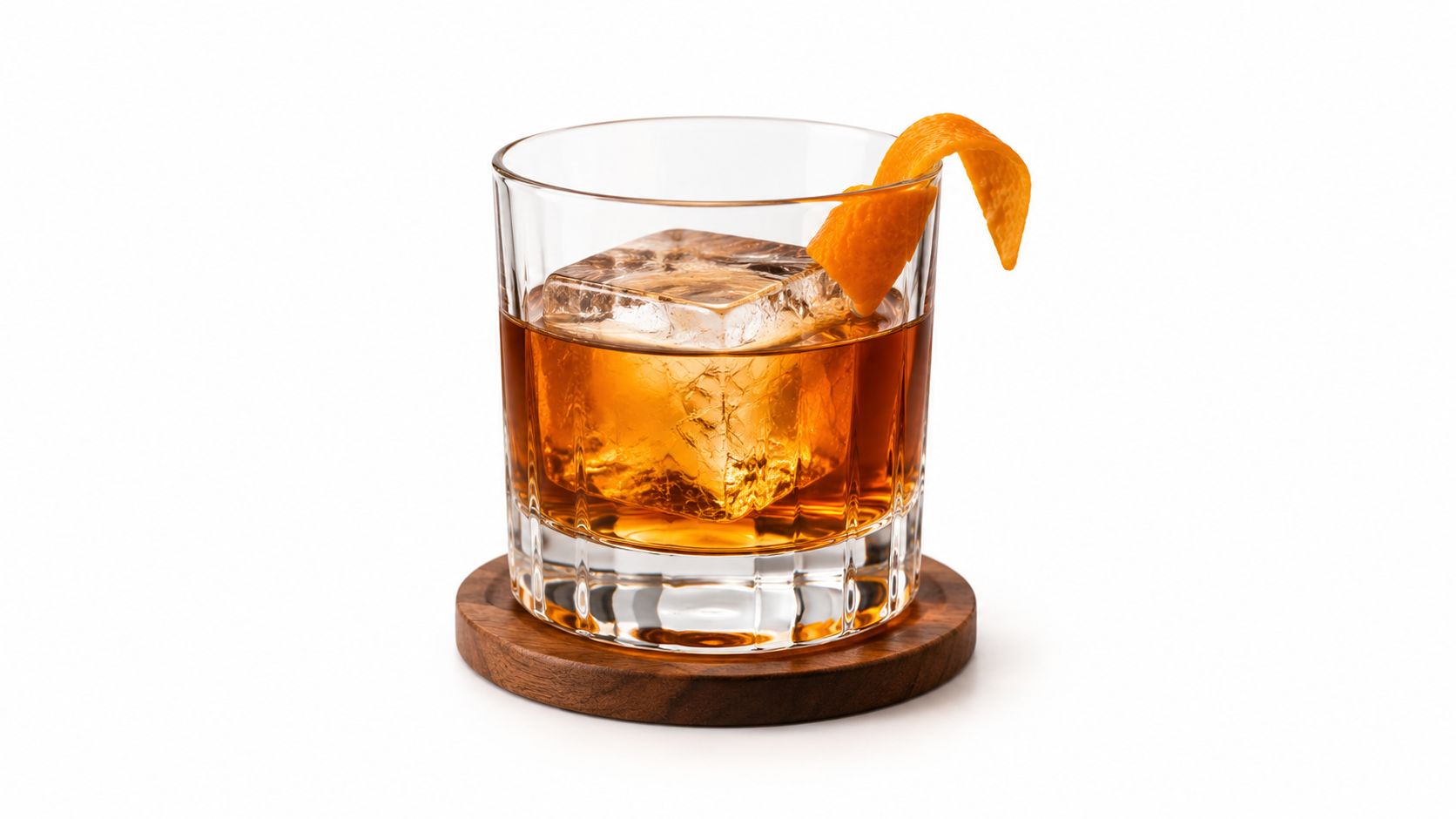 An elegant old fashioned cocktail served in a rocks glass with a large ice cube and orange garnish.
