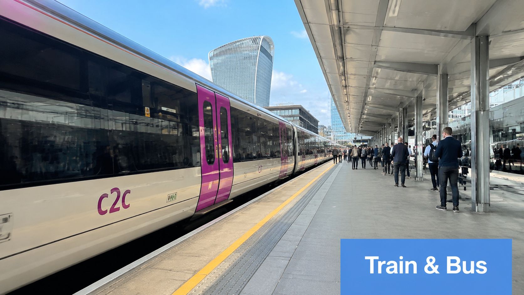 A c2c train waiting at a platform in London near the 20 Fenchurch Street building.