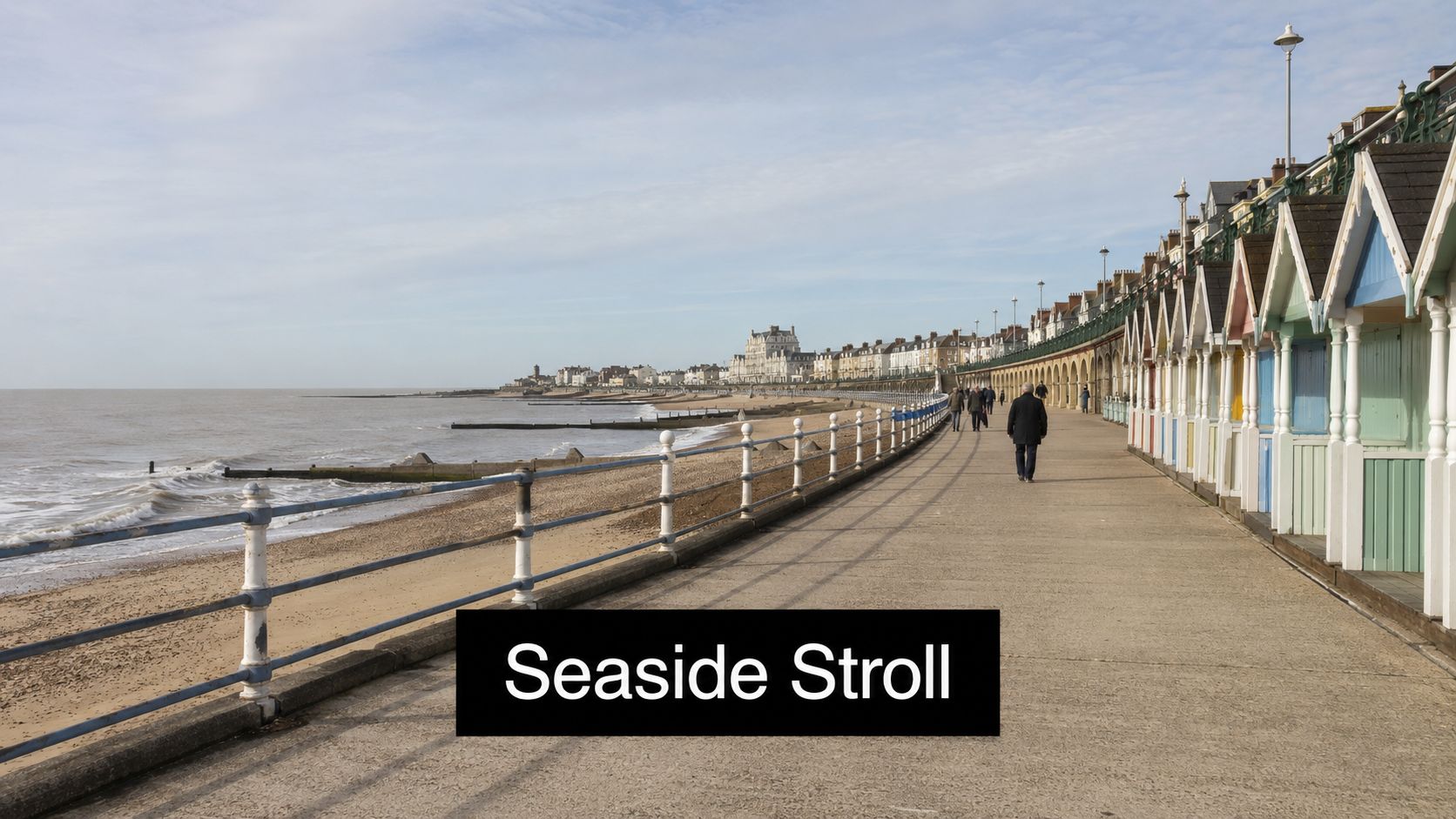 People taking a leisurely seaside stroll along a concrete promenade lined with colorful beach huts in Harwich.