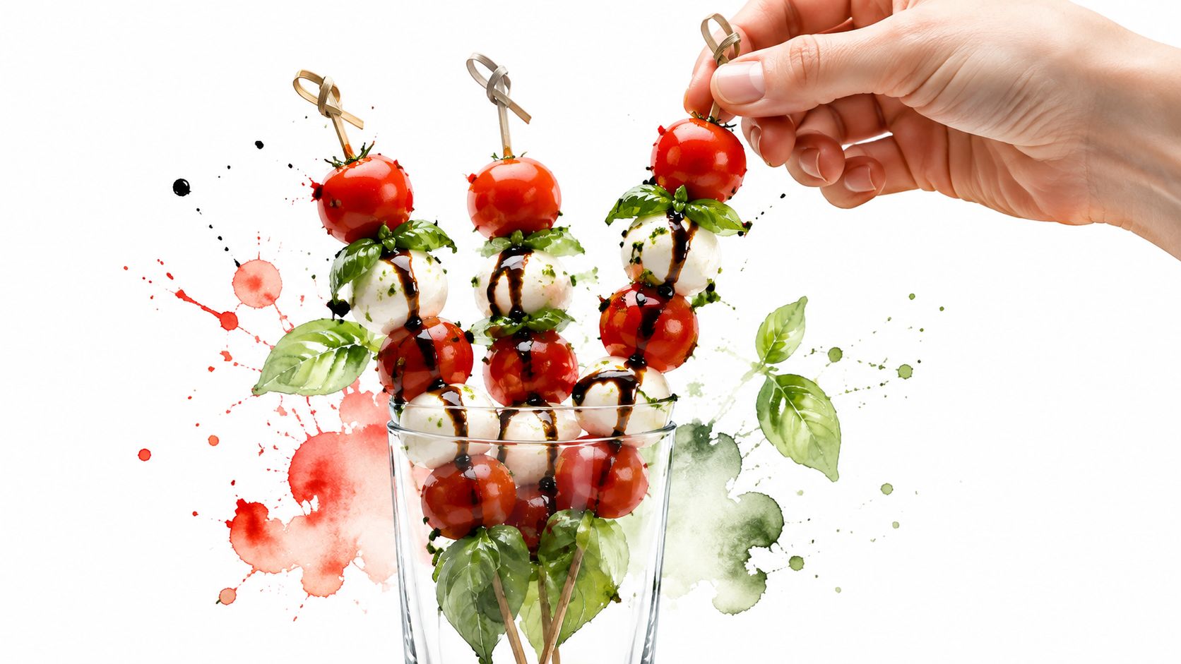 Hand holding a delicious caprese skewer appetizer made with fresh cherry tomatoes, mozzarella pearls, and basil leaves.