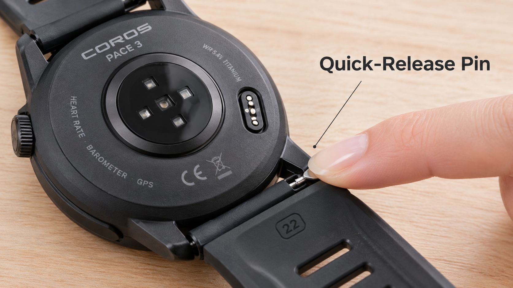 A close-up view showing a finger detaching the quick-release watch band from a Coros Pace 3 sports watch.